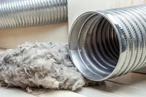 Sho-Me Clean Duct Cleaning—A flexible aluminum dryer vent duct filled with lint at home in Branson, MO.